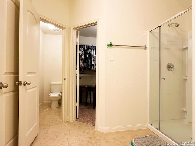 280 Crysanthemum, New Braunfels, TX 78130 - bathroom featuring baseboards, a spacious closet, tile patterned floors, toilet, and a shower stall
