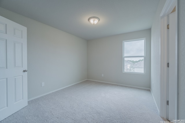 unfurnished bedroom featuring light colored carpet