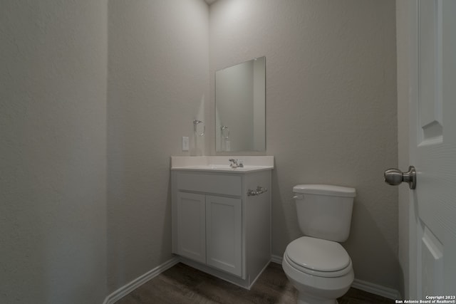 bathroom featuring hardwood / wood-style flooring, vanity, and toilet