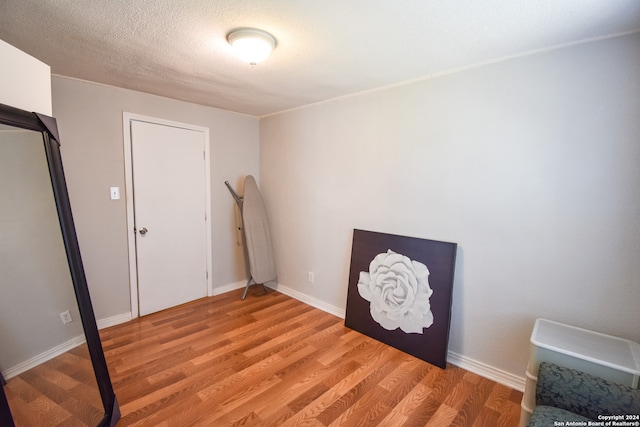 unfurnished bedroom featuring a textured ceiling and light hardwood / wood-style flooring