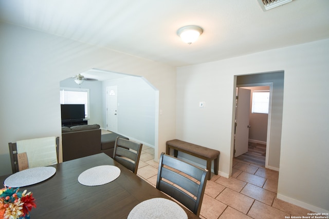 dining room with ceiling fan and light tile patterned flooring