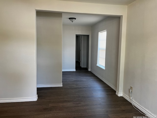 unfurnished room with dark hardwood / wood-style floors