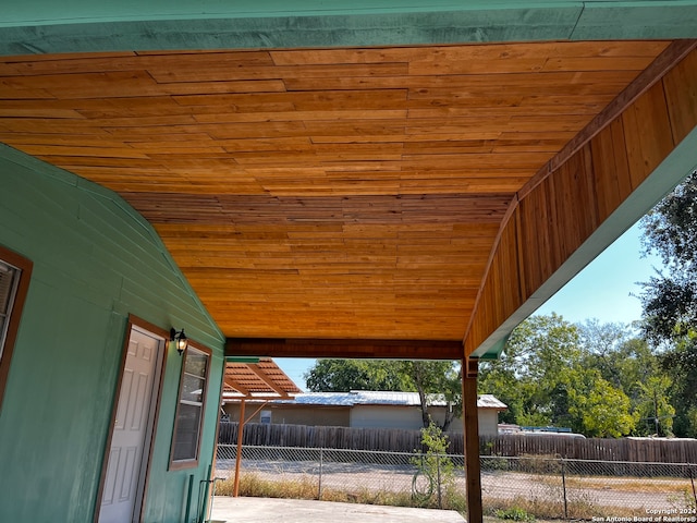 exterior space featuring wooden walls and wood ceiling