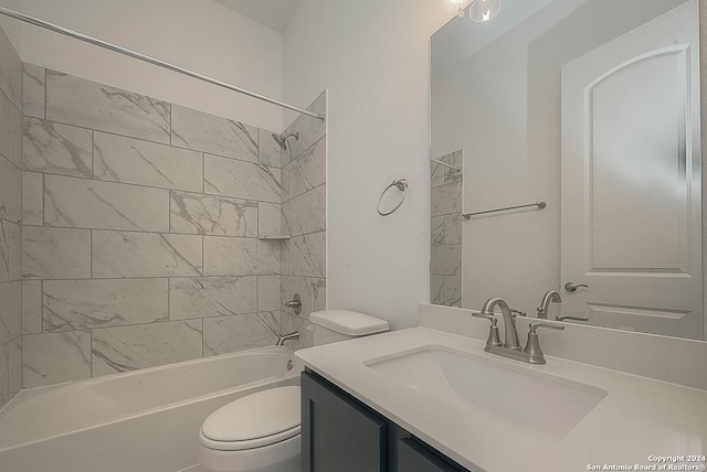 full bathroom with vanity, tiled shower / bath combo, and toilet