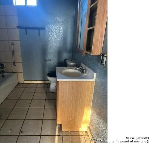 bathroom with vanity, tile patterned flooring, and toilet