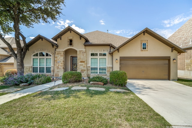 view of front facade with a garage and a front lawn