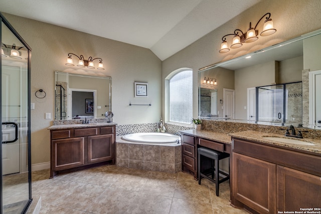 bathroom featuring tile patterned floors, vanity, vaulted ceiling, and shower with separate bathtub