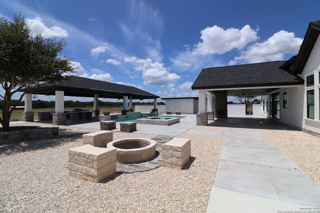 view of patio with a gazebo, exterior kitchen, and an outdoor fire pit