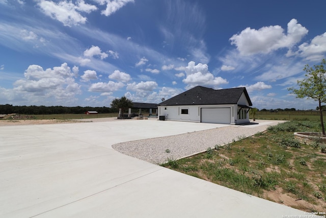 view of home's exterior with stucco siding, an attached garage, and driveway