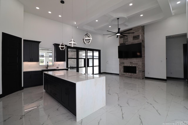 kitchen featuring recessed lighting, a high ceiling, coffered ceiling, dark cabinets, and ceiling fan