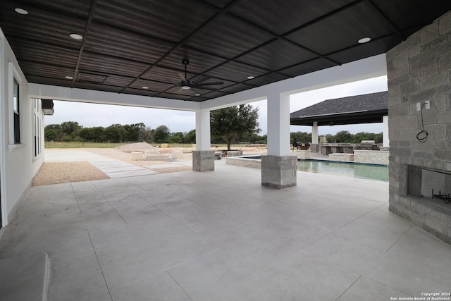 view of patio / terrace with an outdoor pool and a ceiling fan