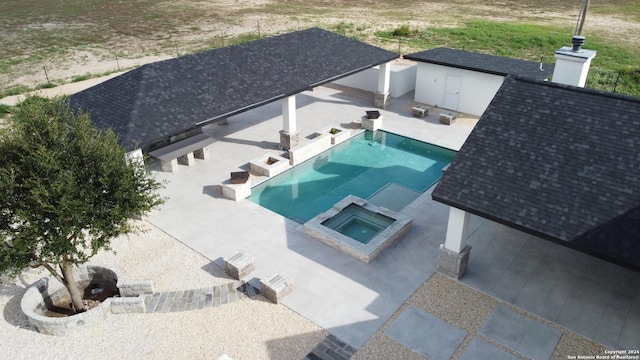 view of swimming pool featuring a patio and a pool with connected hot tub