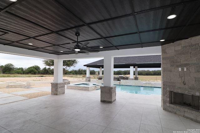 view of swimming pool with an in ground hot tub, ceiling fan, and a patio area