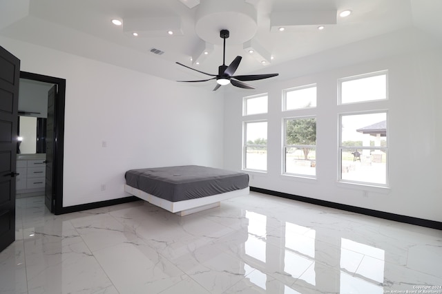 unfurnished bedroom with ceiling fan and a high ceiling