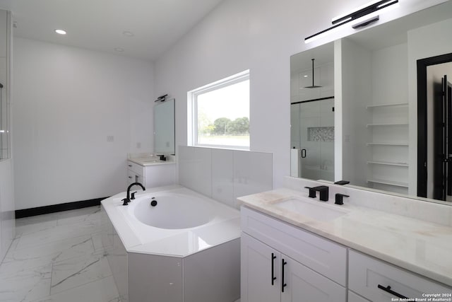 full bath with marble finish floor, a sink, a bath, two vanities, and a stall shower