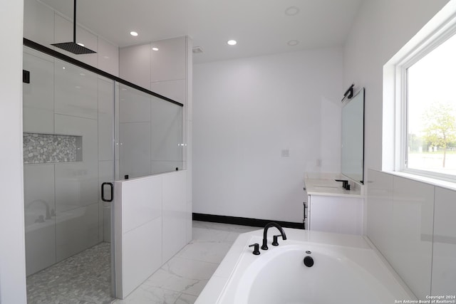 full bath featuring a stall shower, recessed lighting, marble finish floor, a garden tub, and vanity