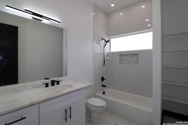 bathroom featuring toilet, vanity, and bathtub / shower combination