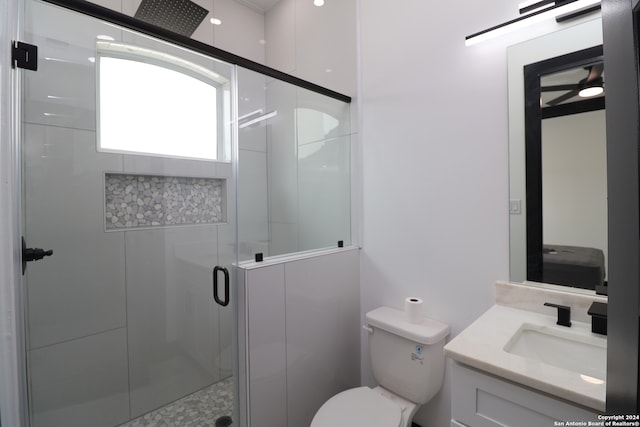 bathroom featuring walk in shower, vanity, and toilet