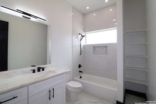 full bathroom featuring tiled shower / bath combo, vanity, and toilet