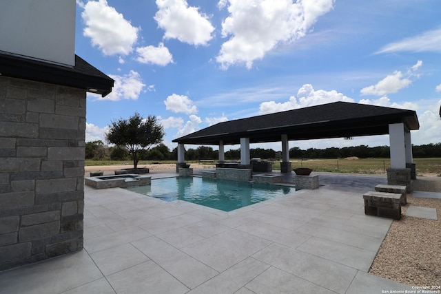 view of pool featuring a gazebo, a pool with connected hot tub, and a patio