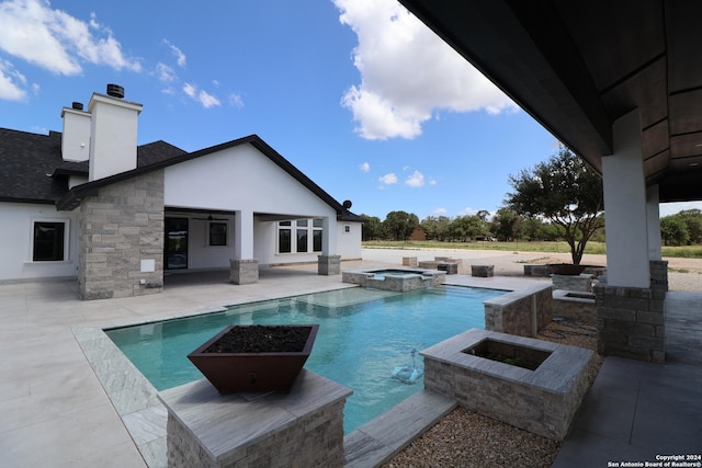 view of pool featuring a pool with connected hot tub and a patio