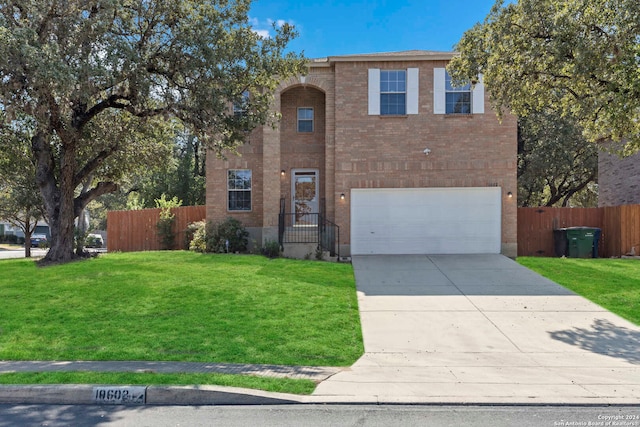 view of front of home with a garage and a front lawn