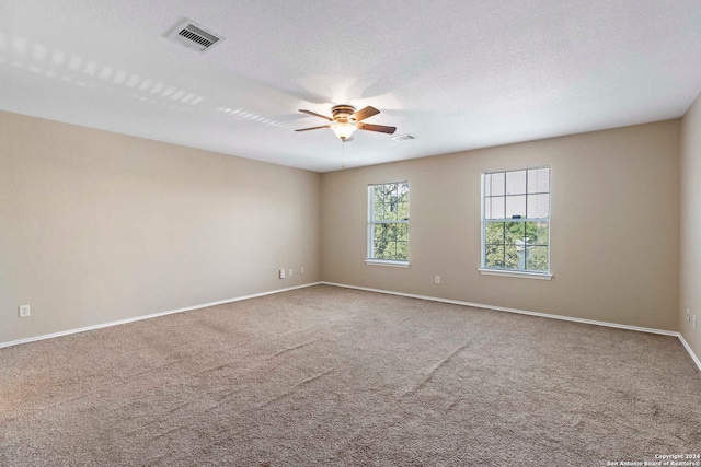 empty room with carpet, a textured ceiling, and ceiling fan