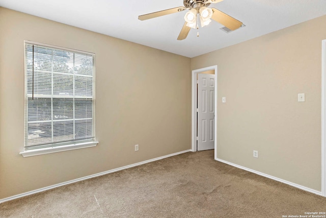 carpeted empty room with ceiling fan