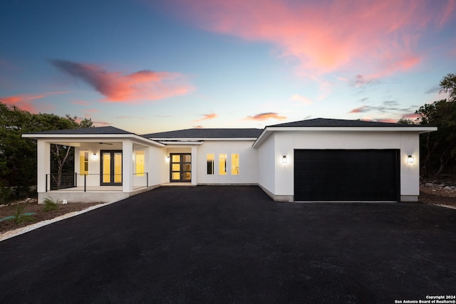 view of front of home featuring a garage and a porch