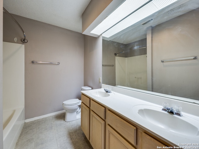 full bathroom with tile patterned floors, vanity, toilet, and  shower combination