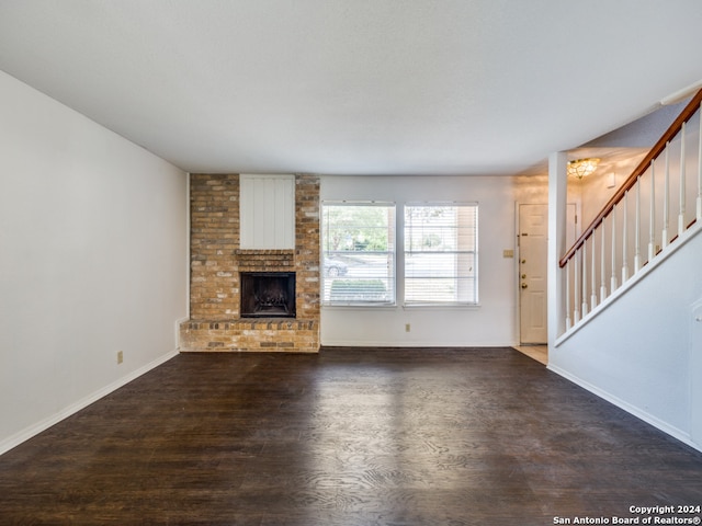 unfurnished living room featuring a fireplace and dark hardwood / wood-style floors