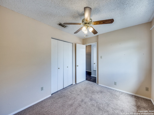 unfurnished bedroom featuring carpet floors, a closet, and ceiling fan