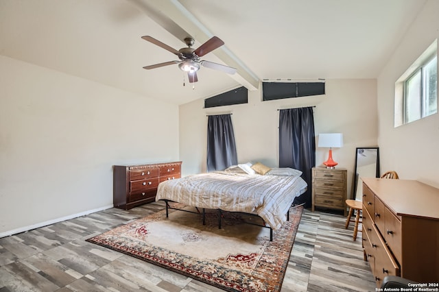 bedroom featuring ceiling fan, lofted ceiling with beams, and light hardwood / wood-style floors