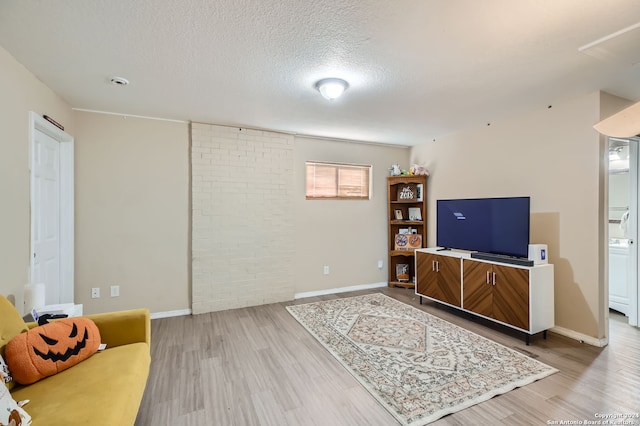 living room featuring light hardwood / wood-style floors and a textured ceiling