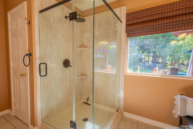 bathroom with tile patterned floors and walk in shower