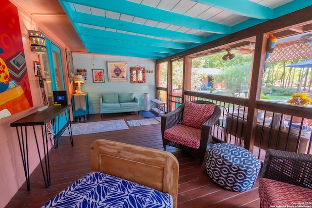 sunroom featuring beamed ceiling