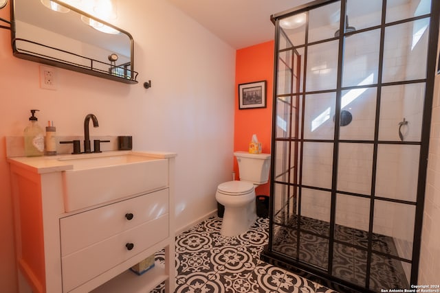 bathroom with a tile shower, tile patterned floors, vanity, and toilet