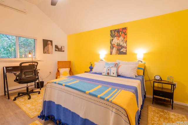 bedroom featuring ceiling fan, lofted ceiling, a wall unit AC, and hardwood / wood-style flooring