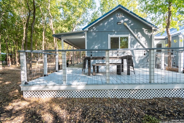 back of house with a wooden deck