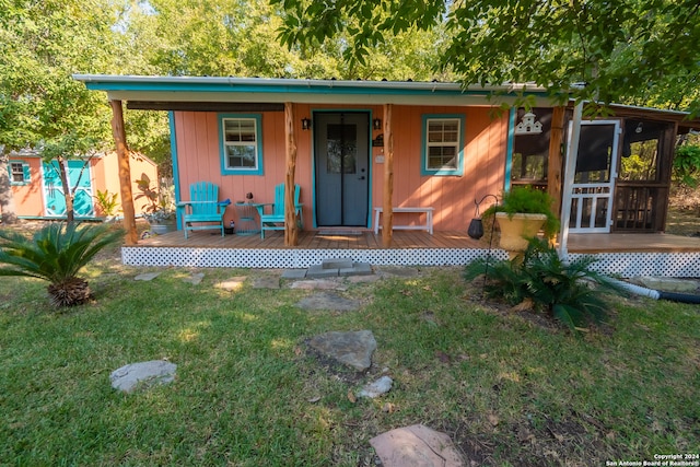 exterior space featuring a front lawn and covered porch