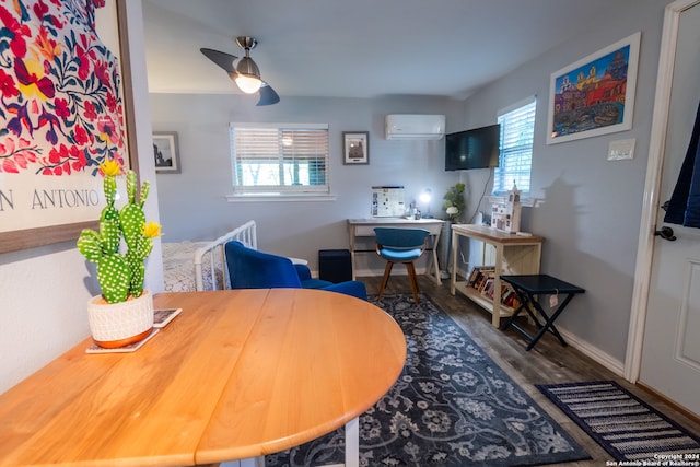 dining room with hardwood / wood-style flooring, a wall unit AC, and ceiling fan