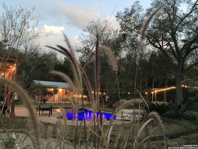 view of pool at dusk