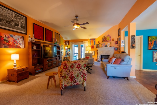 living room featuring ceiling fan, light carpet, and vaulted ceiling