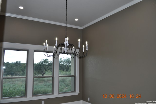 interior details with an inviting chandelier and crown molding