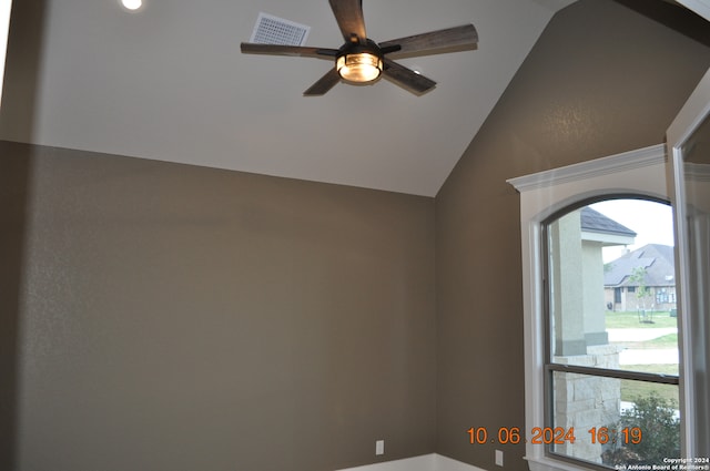 unfurnished room with ceiling fan and vaulted ceiling