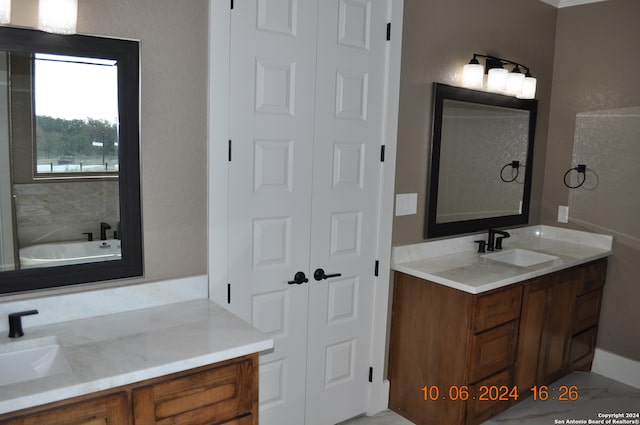 bathroom with vanity and a tub