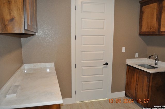 interior space featuring light wood-type flooring and sink