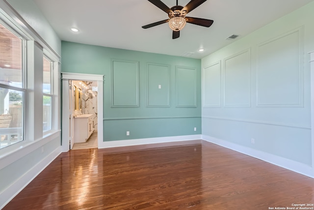 spare room featuring dark hardwood / wood-style floors and ceiling fan