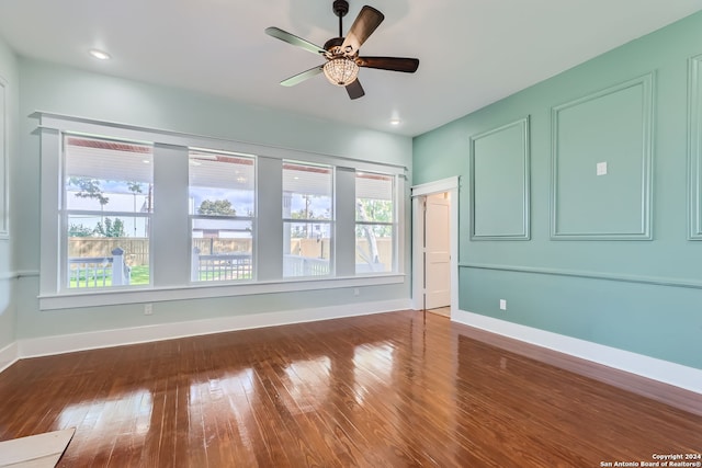 unfurnished bedroom with dark wood-type flooring, ceiling fan, and multiple windows