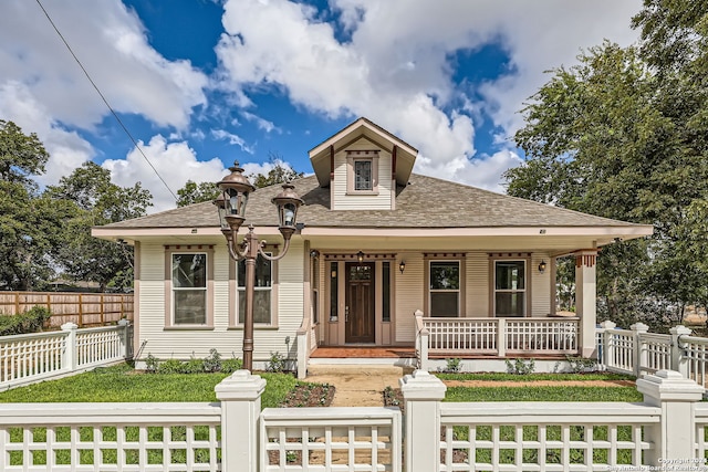 bungalow-style house with a porch and a front yard